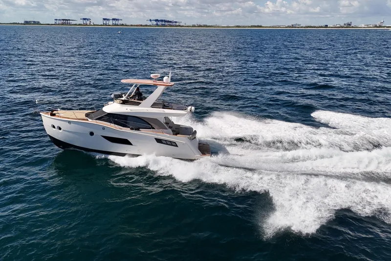 Slide: The Image of 2014 Carver 40 Command Bridge yacht cruising on open water. - 20