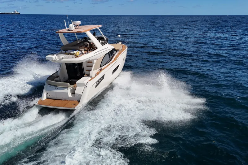 Slide: The Image of 2014 Carver 40 Command Bridge yacht cruising on open sea. - 21