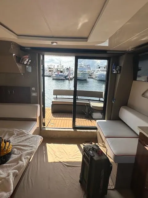 Slide: The Image of Interior of 2014 Carver C40 Command Bridge yacht with harbor view through sliding doors. - 24