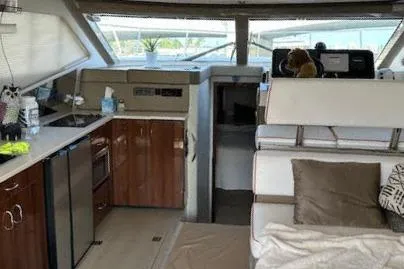 Slide: The Image of Interior of 2014 Carver C40 Command Bridge yacht with kitchen and seating area. - 25