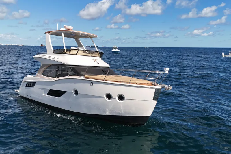 Slide: The Image of 2014 Carver 40 Command Bridge yacht cruising on open sea under blue sky. - 8