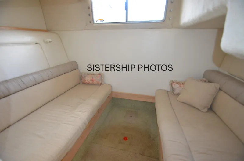 Slide: The Image of Interior of 1999 Maxum 3300 SCR boat with beige seating and window. - 12