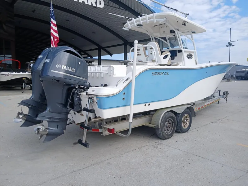 Slide: The Image of 2015 Sea Fox 286 Commander boat on trailer with Yamaha engines, parked outdoors. - 15