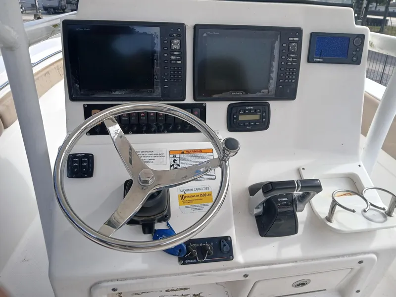 Slide: The Image of Control panel of 2015 Sea Fox 286 Commander boat with steering wheel and navigation screens. - 3