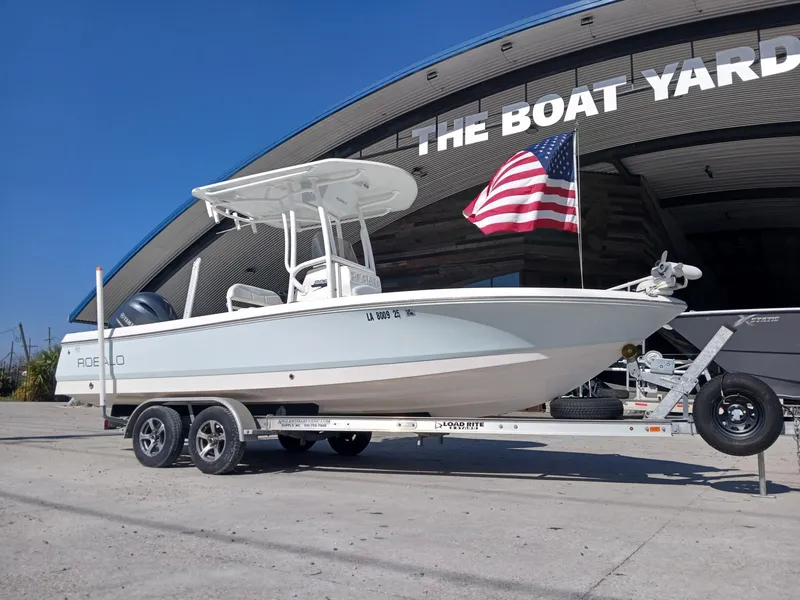 Slide: The Image of 2018 Robalo 226 Cayman boat on trailer at The Boat Yard, with American flag. - 11