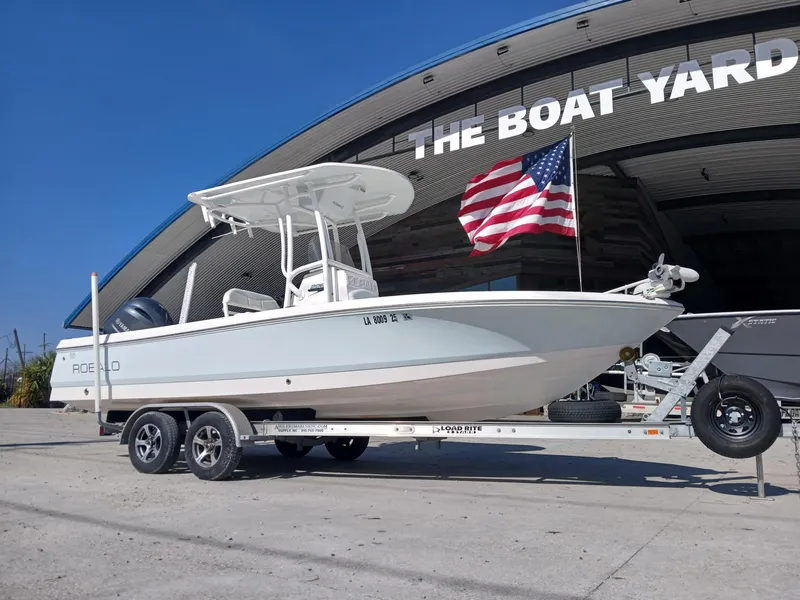 Slide: The Image of 2018 Robalo 226 Cayman boat on trailer, American flag, outside The Boat Yard. - 16