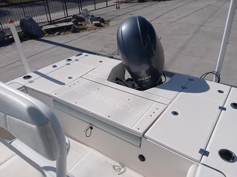 Slide: The Image of 2018 Robalo 226 Cayman boat with outboard motor, docked on concrete surface. - 5