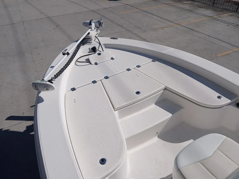 Slide: The Image of 2018 Robalo 226 Cayman boat deck with trolling motor, white finish, spacious layout. - 6