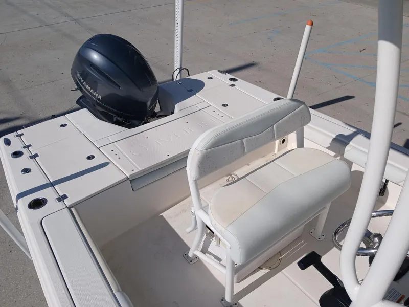 Slide: The Image of 2018 Robalo 226 Cayman boat interior with seating and motor. - 8