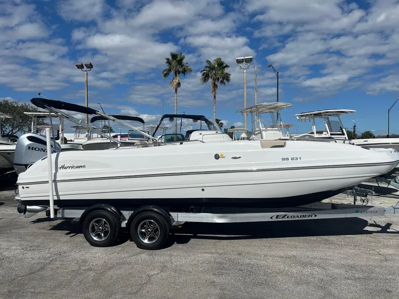 The Image of 2022 Hurricane Center Console SS 231 OB boat on trailer, parked outdoors under a blue sky. - 0