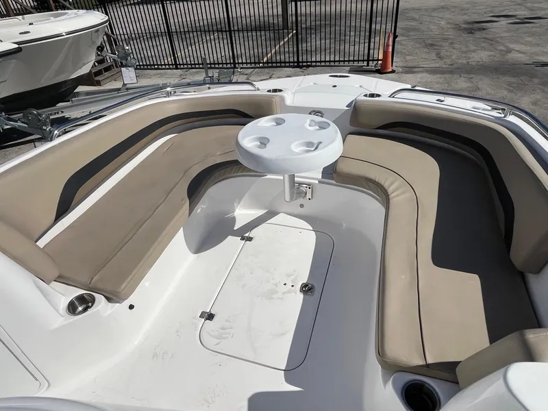 Slide: The Image of 2022 Hurricane Center Console SS 231 OB boat with beige seating and round table. - 2