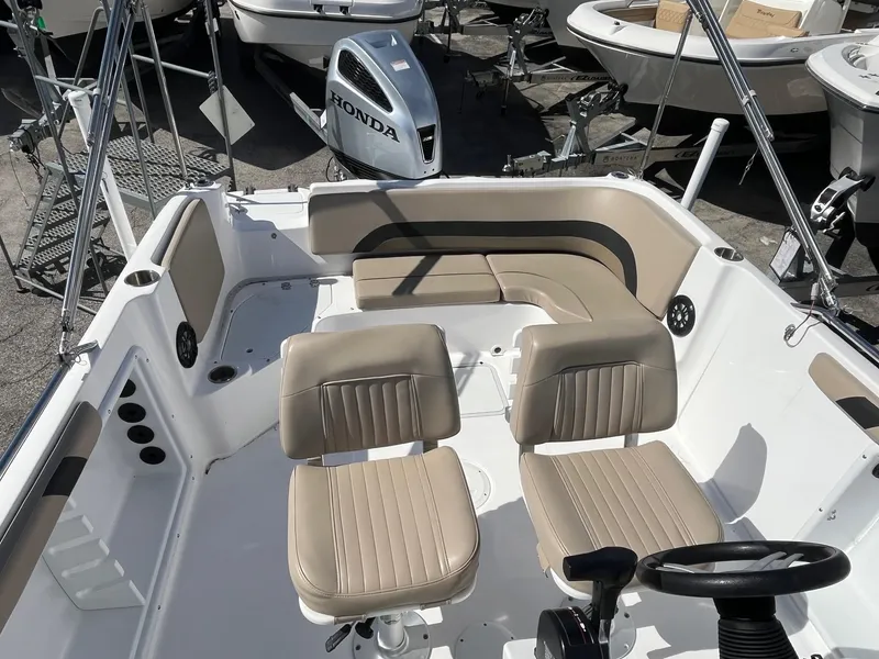 Slide: The Image of 2022 Hurricane Center Console SS 231 OB boat interior with beige seating and steering wheel. - 5