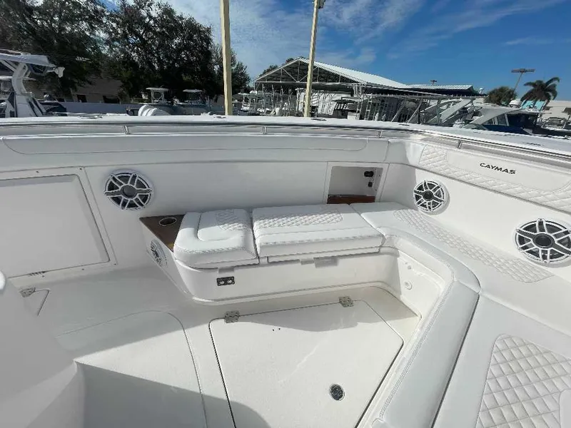 Slide: The Image of 2024 Caymas 401 CC boat interior with white seating and speakers. - 12