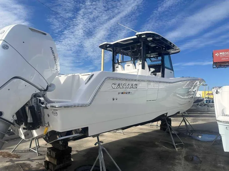 Slide: The Image of 2024 Caymas 401 CC boat on display, featuring sleek design and powerful Mercury engines. - 7