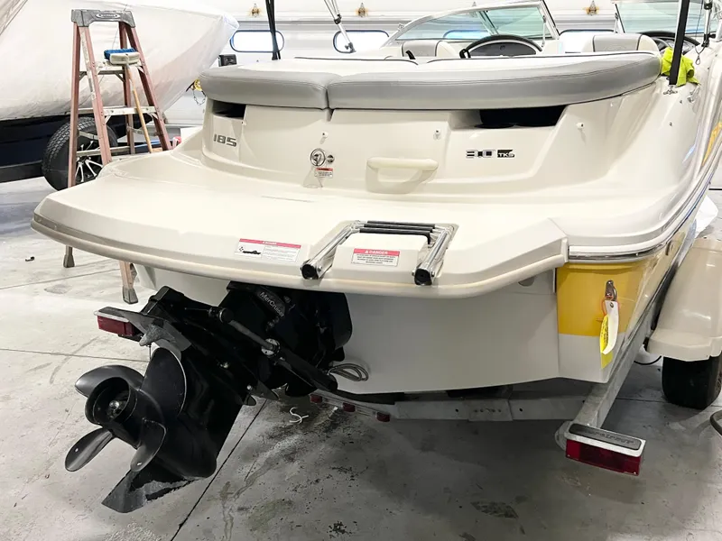 Slide: The Image of 2009 Sea Ray 185 Sport boat, rear view, in a garage setting. - 2