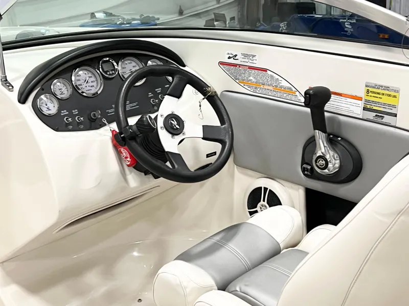 Slide: The Image of 2009 Sea Ray 185 Sport boat interior with steering wheel and control panel. - 4