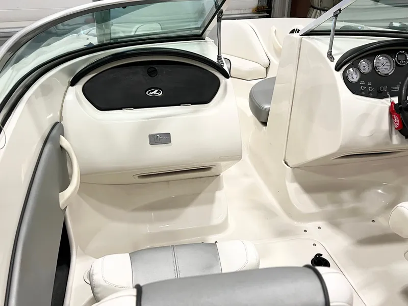 Slide: The Image of 2009 Sea Ray 185 Sport boat interior with white seating and dashboard controls. - 5