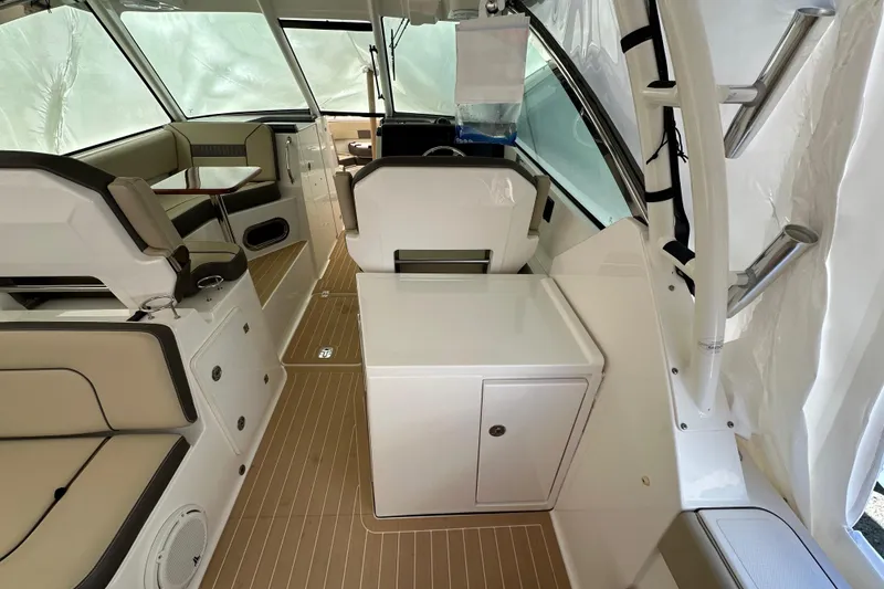 Slide: The Image of 2019 Pursuit DC 325 Dual Console interior with seating and storage, featuring a sleek design. - 12