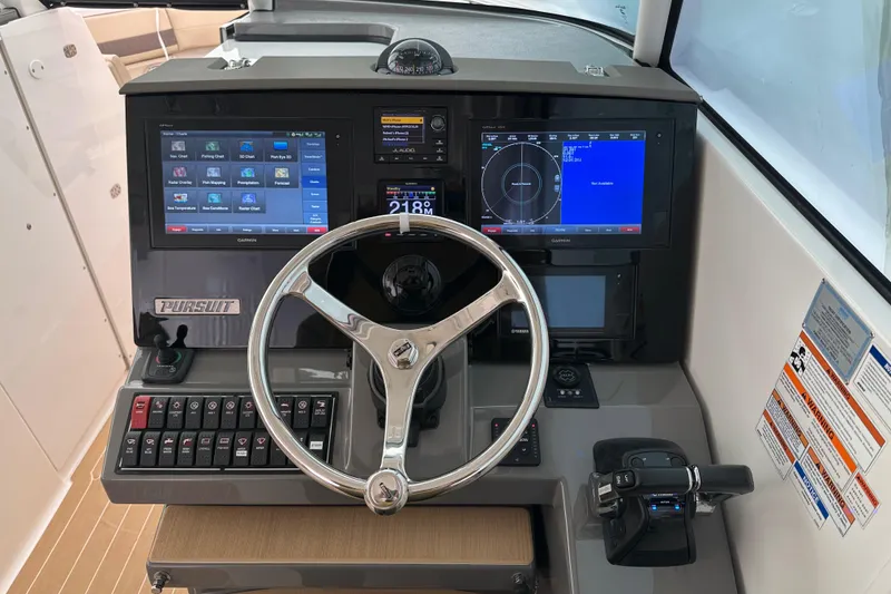 Slide: The Image of 2019 Pursuit DC 325 Dual Console dashboard with steering wheel and digital displays. - 27