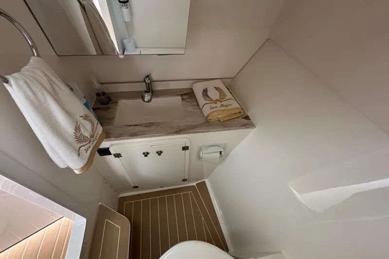 Slide: The Image of 2019 Pursuit DC 325 Dual Console bathroom with sink, mirror, and towels. - 34
