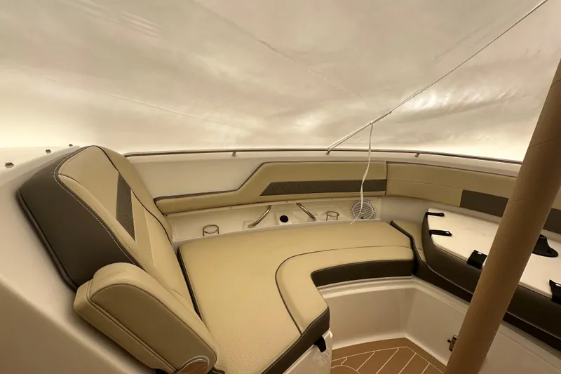 Slide: The Image of 2019 Pursuit DC 325 Dual Console interior with beige seating and sleek design. - 40