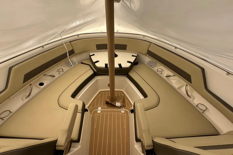 Slide: The Image of 2019 Pursuit DC 325 Dual Console interior with beige seating and wood flooring. - 43