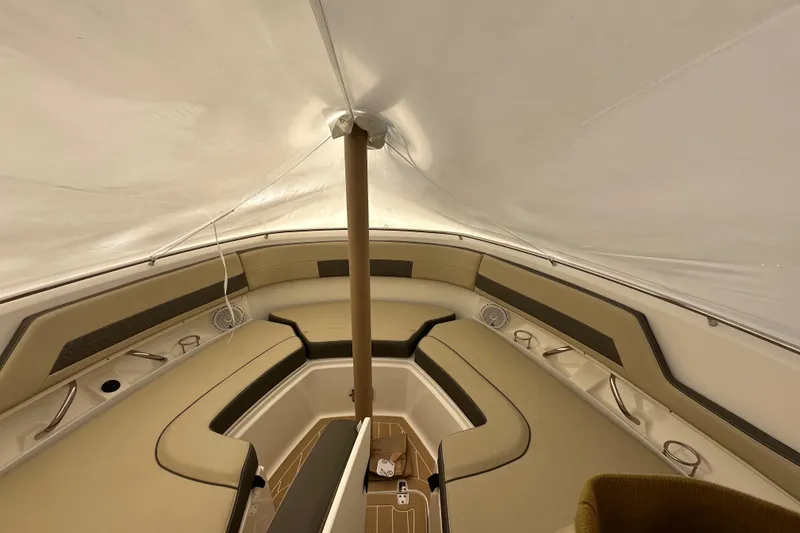 Slide: The Image of 2019 Pursuit DC 325 Dual Console interior with beige seating and canopy. - 46