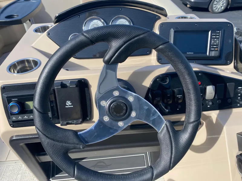 Slide: The Image of Steering wheel and dashboard of 2025 SunCatcher Select 322RC boat. - 12