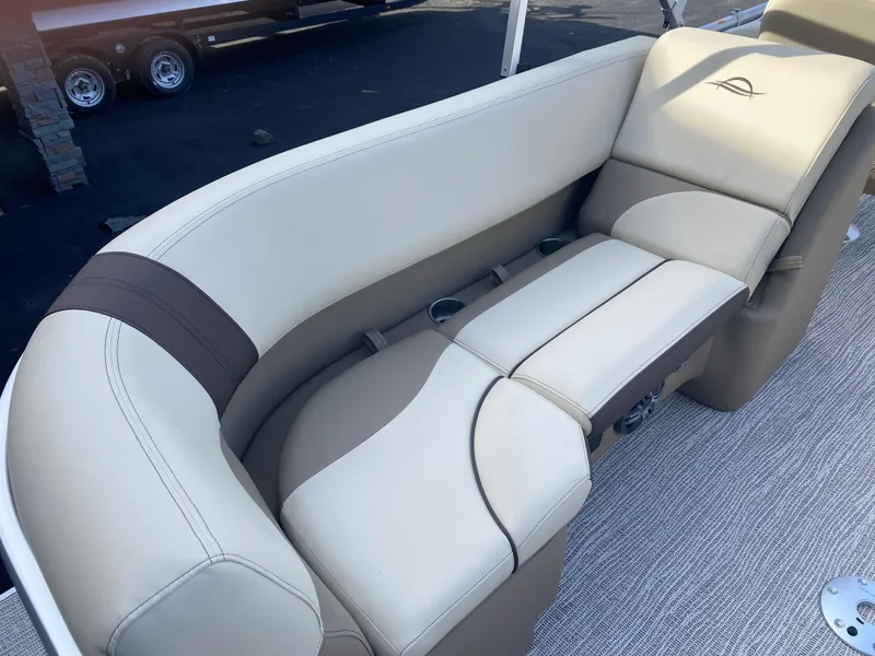 Slide: The Image of Luxurious seating on 2025 SunCatcher Select 322RC boat, featuring beige and brown upholstery. - 13