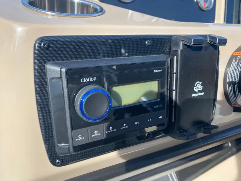 Slide: The Image of 2025 SunCatcher Select 322RC boat dashboard with Clarion audio system. - 21