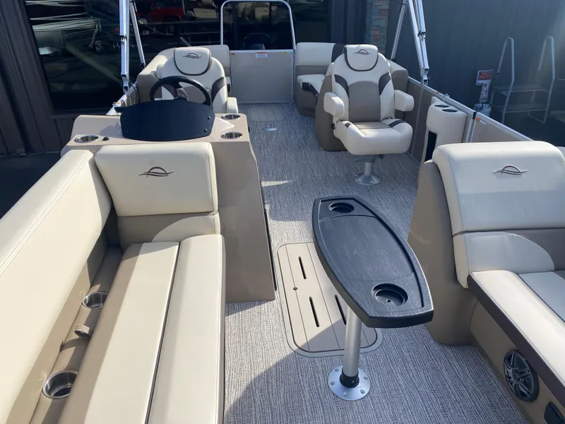 Slide: The Image of 2025 SunCatcher Select 322RC boat interior with beige seating and central table. - 26