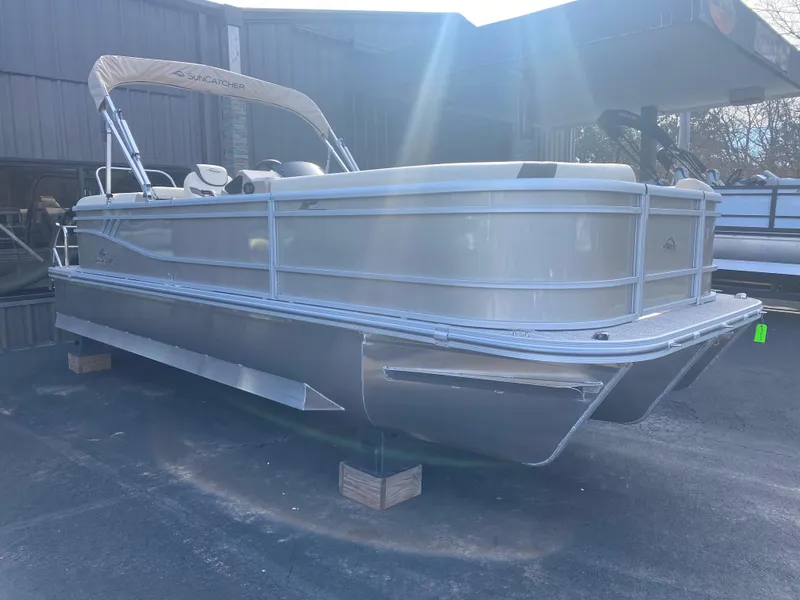 Slide: The Image of 2025 SunCatcher Select 322RC pontoon boat in storage, side view. - 3
