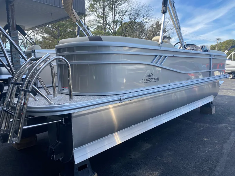 Slide: The Image of 2025 SunCatcher Select 322RC pontoon boat with sleek silver design and ladder. - 5