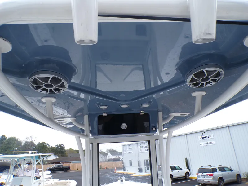 Slide: The Image of 2024 Parker 2400 Center Console boat with blue T-top and speakers. - 13
