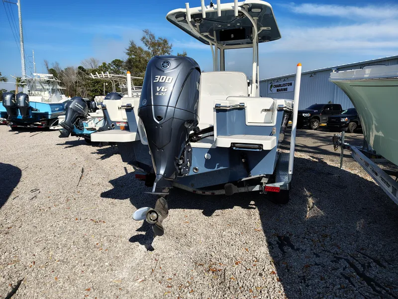 Slide: The Image of 2024 Parker 2400 Center Console boat with Yamaha 300 V6 engine, parked on gravel. - 14