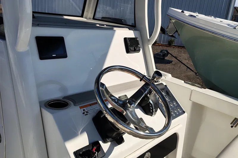 Slide: The Image of 2024 Parker 2400 Center Console boat steering wheel and control panel. - 15