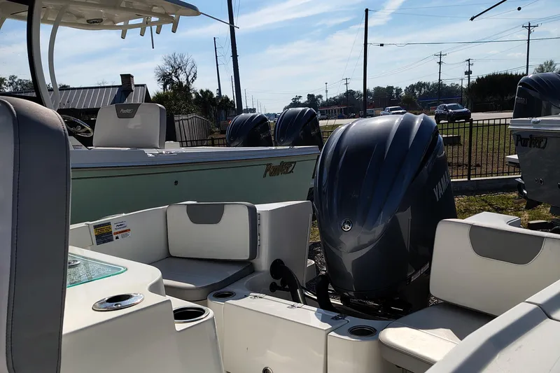 Slide: The Image of 2024 Parker 2400 Center Console boat with Yamaha outboard engines, docked outdoors. - 17