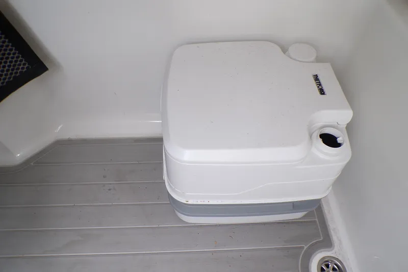 Slide: The Image of Portable toilet on 2024 Parker 2400 Center Console boat, gray flooring. - 22