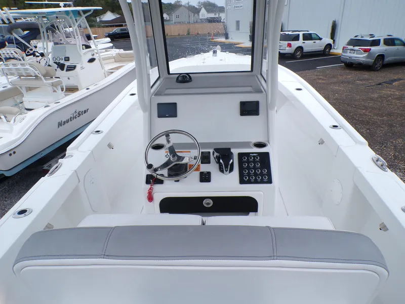 Slide: The Image of 2024 Parker 2400 Center Console boat interior with steering wheel and control panel. - 4