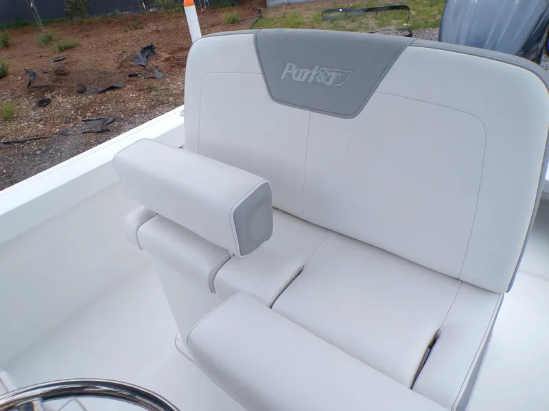 Slide: The Image of 2024 Parker 2400 Center Console boat seat with armrest, featuring sleek white upholstery. - 8