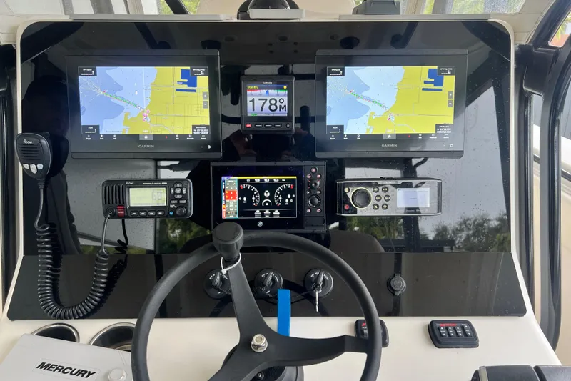 Slide: The Image of Control panel of a 2011 Blackwater 36 Sportfish boat with navigation screens and instruments. - 6