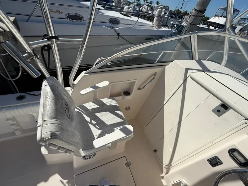 Slide: The Image of 2006 Cobia 250 Walk-Around boat interior with helm seat and control panel. - 10