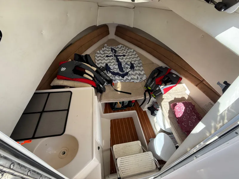 Slide: The Image of Interior of 2006 Cobia 250 Walk-Around boat with seating and life jackets. - 14