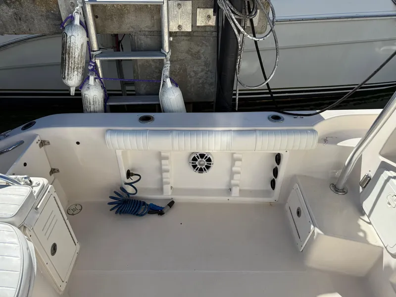 Slide: The Image of 2006 Cobia 250 Walk-Around boat interior with seating and storage compartments. - 17