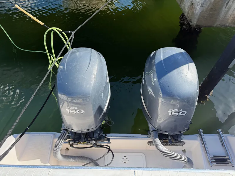 Slide: The Image of Twin Yamaha 150 outboard motors on a 2006 Cobia 250 Walk-Around boat. - 20