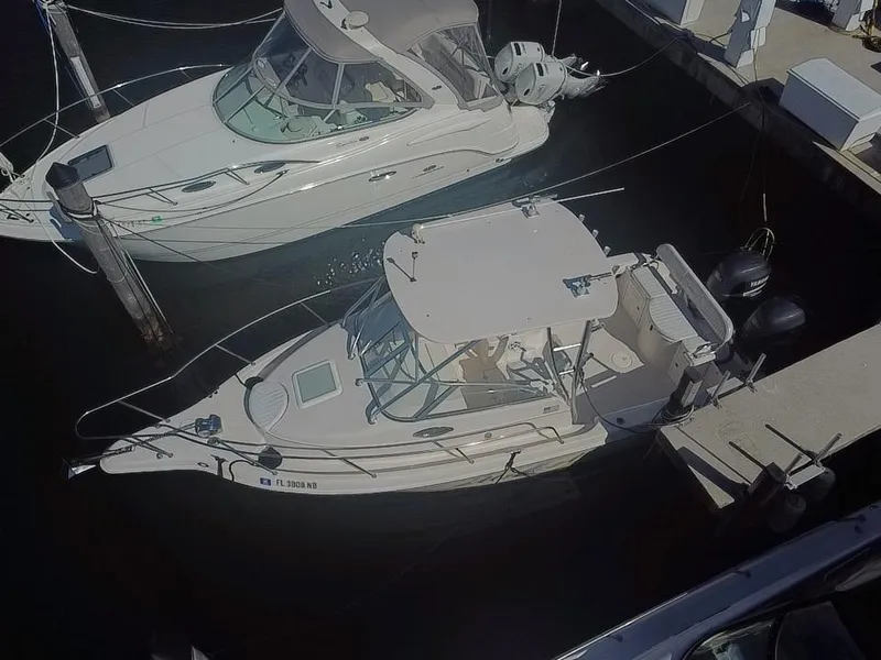 Slide: The Image of 2006 Cobia 250 Walk-Around boat docked at marina, aerial view. - 3