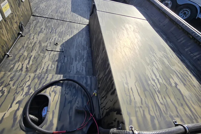 Slide: The Image of 2025 SeaArk DXS 1860 SLD boat interior with camouflage pattern and wiring details. - 5