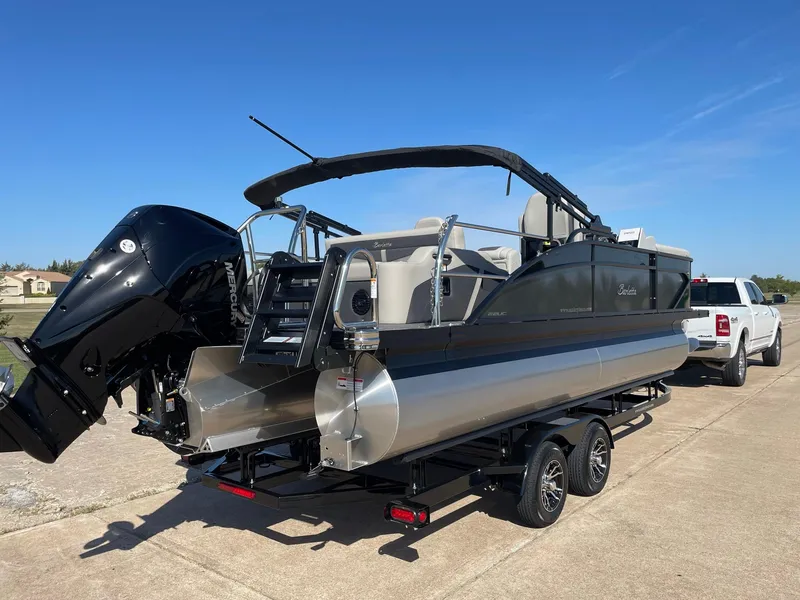 Slide: The Image of 2024 Barletta Cabrio 22UC pontoon boat on trailer, rear view, sunny day. - 12