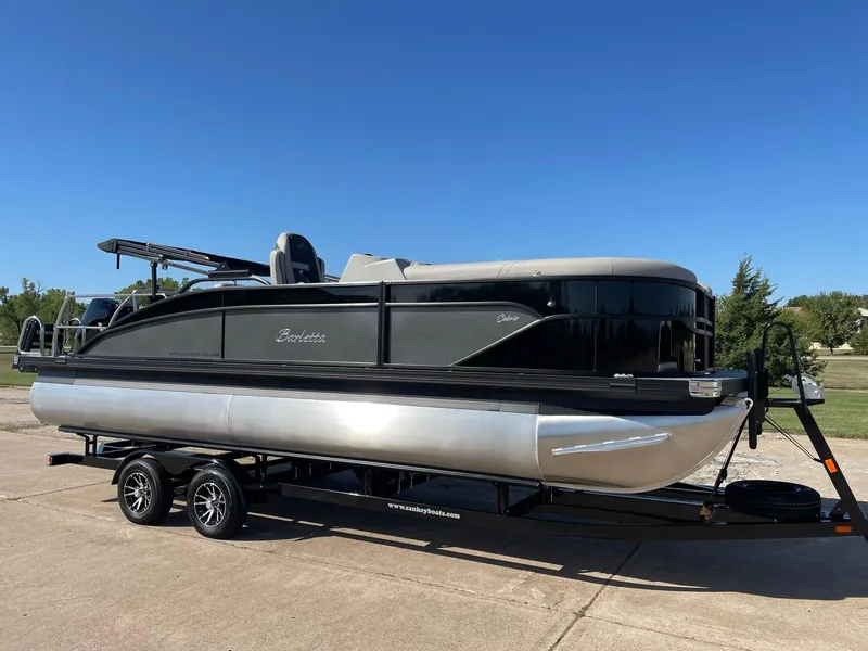 Slide: The Image of 2024 Barletta Cabrio 22UC pontoon boat on trailer, parked outdoors. - 15