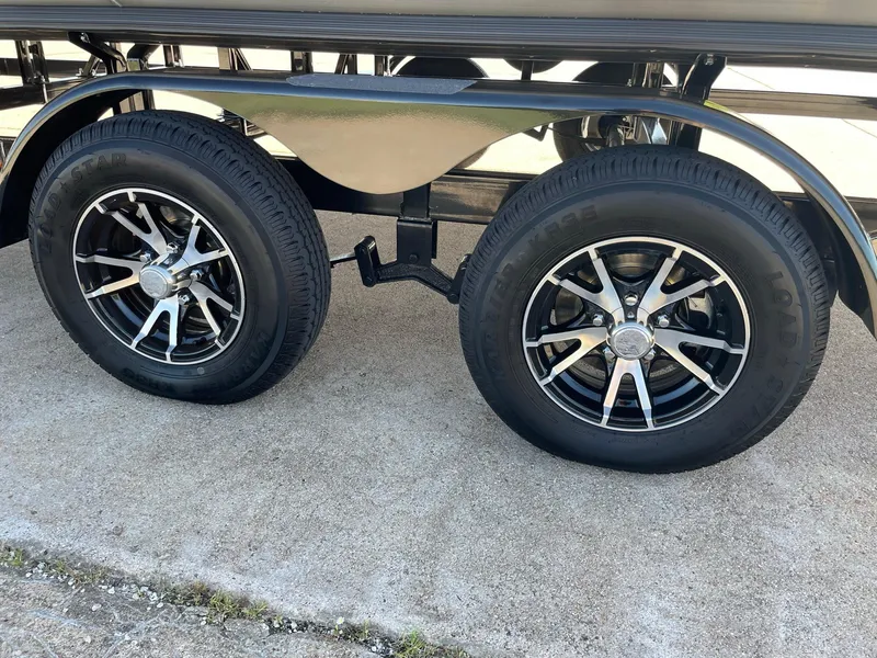 Slide: The Image of 2024 Barletta Cabrio 22UC trailer wheels on concrete surface. - 18